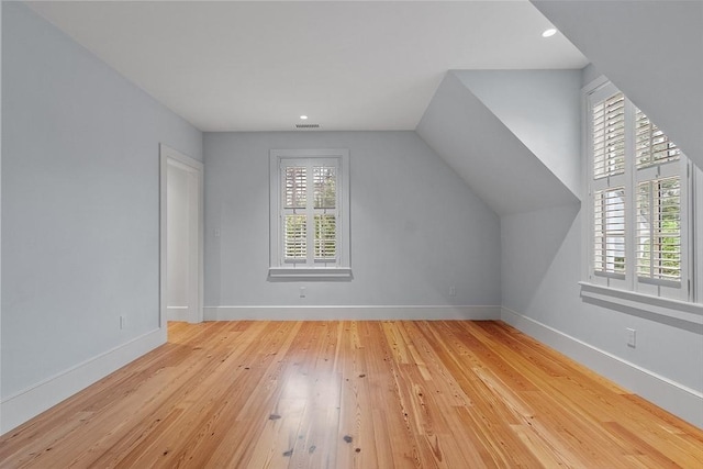 bonus room featuring wood-type flooring, recessed lighting, baseboards, vaulted ceiling, and visible vents