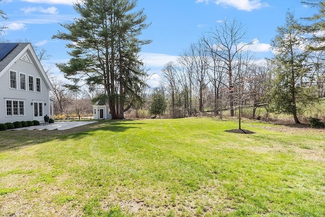 view of yard with an outdoor structure and a patio area