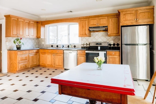 kitchen featuring appliances with stainless steel finishes, ornamental molding, and backsplash