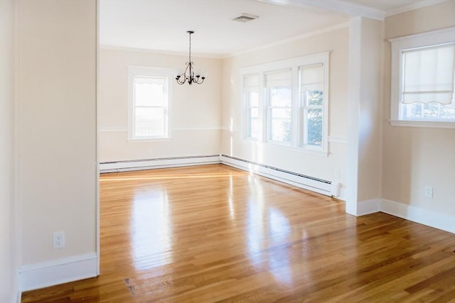 spare room with hardwood / wood-style floors, a baseboard radiator, a chandelier, and a wealth of natural light