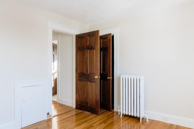 hall with hardwood / wood-style floors and radiator