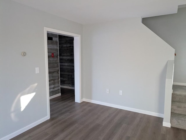 spare room featuring dark hardwood / wood-style flooring