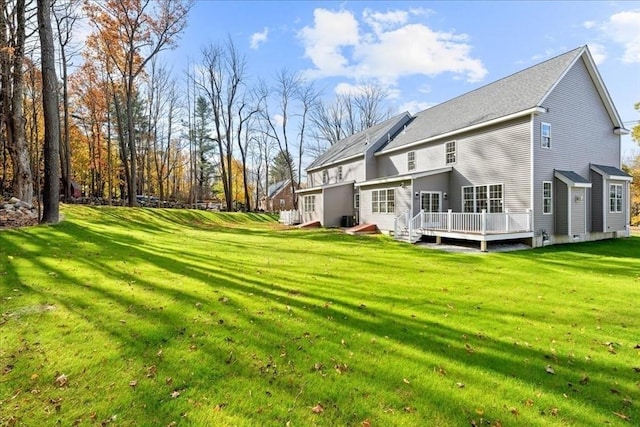 70 Princeton St, Holden, MA 01522 - rear view of house featuring central air condition unit, roof with shingles, a wooden deck, and a lawn