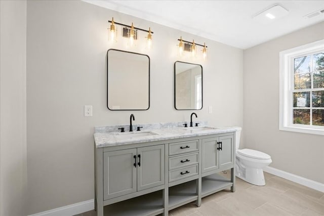 70 Princeton St, Holden, MA 01522 - bathroom with double vanity, baseboards, and toilet