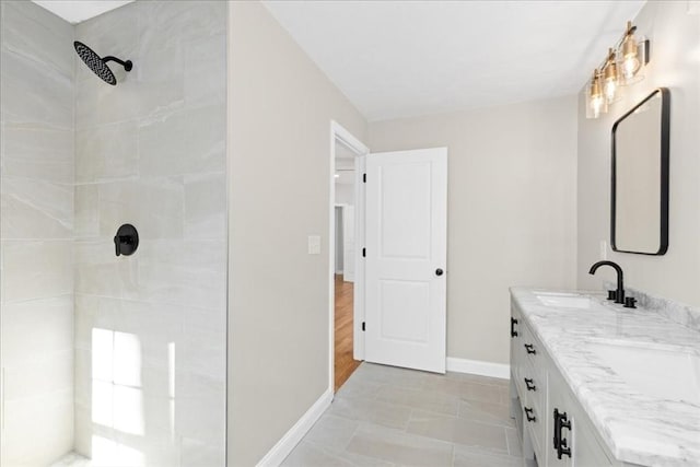 70 Princeton St, Holden, MA 01522 - full bath featuring baseboards, tiled shower, double vanity, and a sink