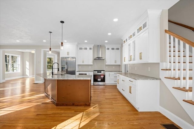 70 Princeton St, Holden, MA 01522 - kitchen with light wood-style flooring, a sink, wall chimney exhaust hood, appliances with stainless steel finishes, and recessed lighting