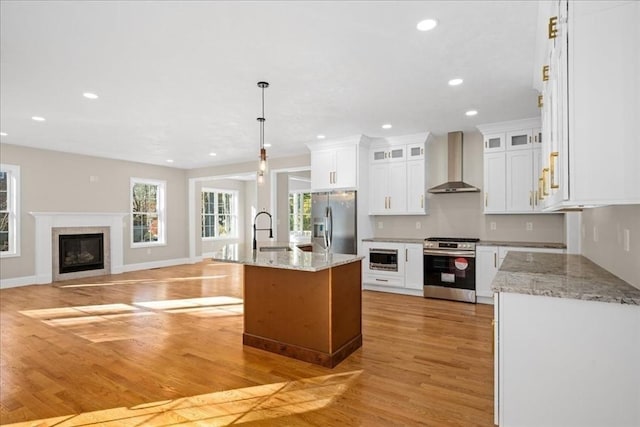 70 Princeton St, Holden, MA 01522 - kitchen featuring recessed lighting, stainless steel appliances, light wood-type flooring, and wall chimney exhaust hood