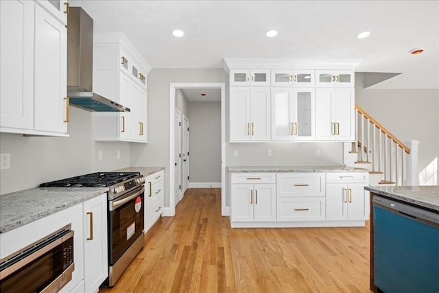 70 Princeton St, Holden, MA 01522 - kitchen featuring light wood finished floors, wall chimney exhaust hood, white cabinets, and appliances with stainless steel finishes