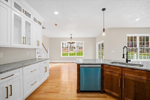 70 Princeton St, Holden, MA 01522 - kitchen with light wood finished floors, hanging light fixtures, dishwashing machine, a sink, and a chandelier