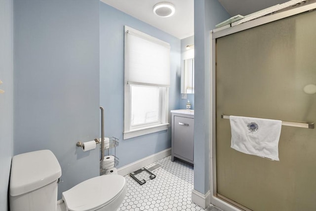 bathroom with toilet, vanity, and walk in shower