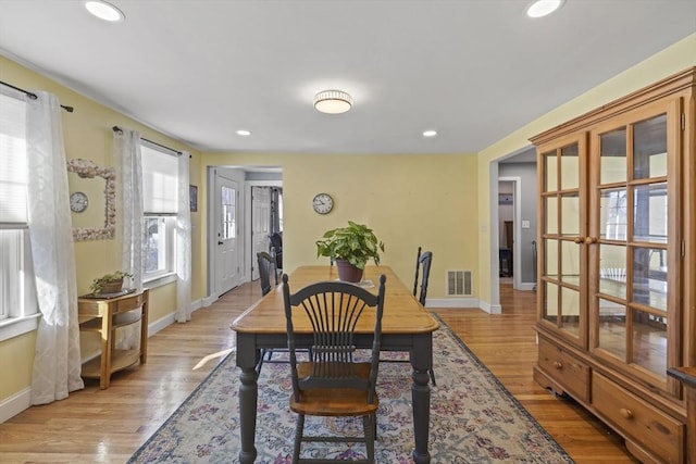 dining space with light hardwood / wood-style floors