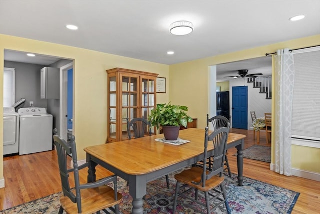 dining space featuring washer and dryer, ceiling fan, and light wood-type flooring