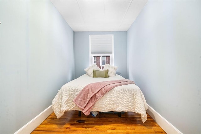 bedroom with hardwood / wood-style floors