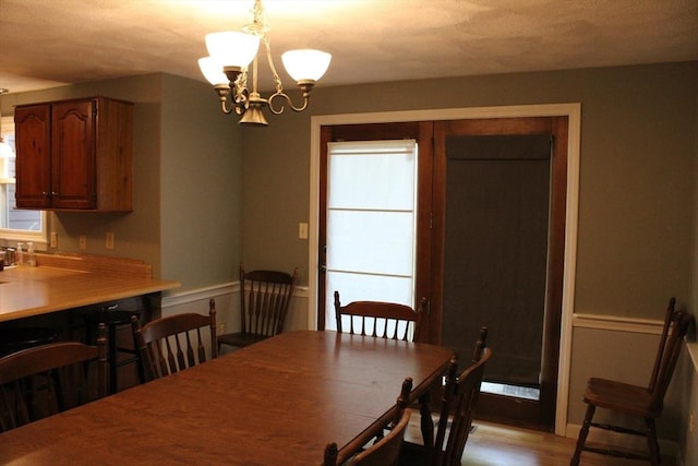 139 Wellman Ave Unit 139, Chelmsford, MA 01863 - dining room with a chandelier and light wood finished floors