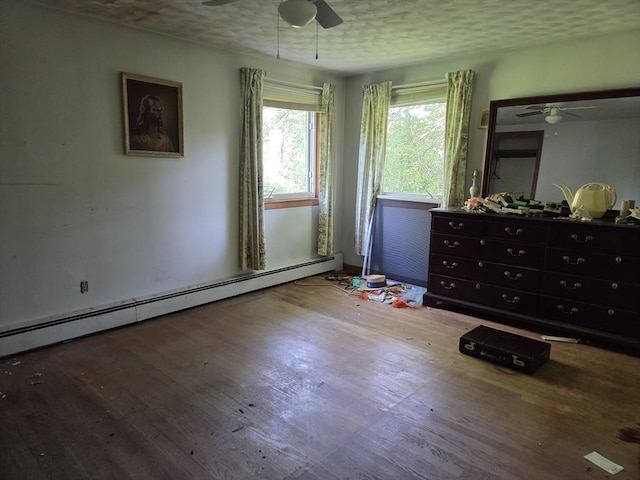 417 Bigelow St, Marlborough, MA 01752 - bedroom with a baseboard heating unit, wood finished floors, and a ceiling fan