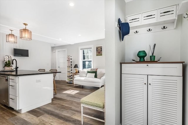 interior space with a sink, recessed lighting, and dark wood-style flooring