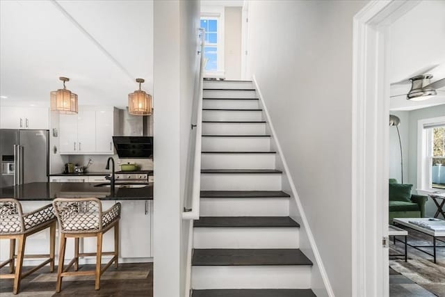 stairway featuring baseboards and wood finished floors