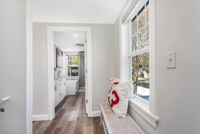 corridor with baseboards and dark wood-style floors