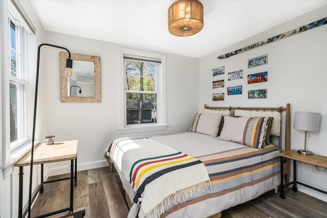 bedroom featuring baseboards and wood finished floors