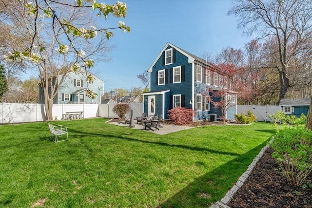 back of property with a yard, a patio, and a fenced backyard