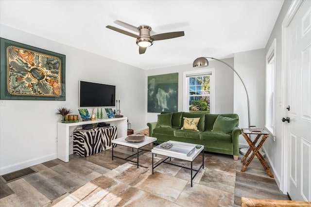 living area with baseboards, ceiling fan, wood finished floors, and visible vents