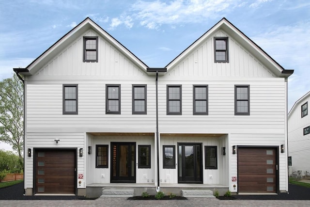 276-278 Nevada Unit 276, Newton, MA 02460 - view of front facade with board and batten siding, decorative driveway, and an attached garage