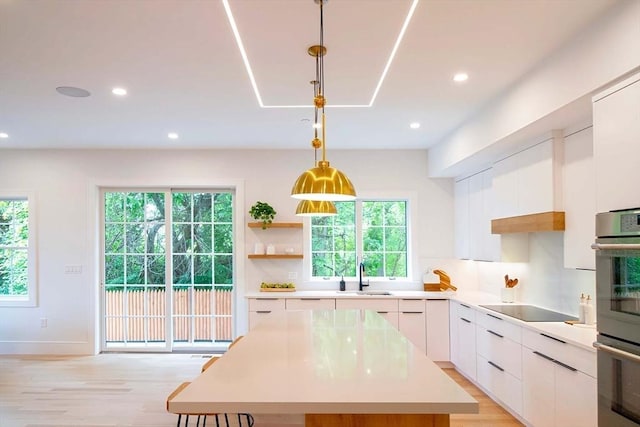 276-278 Nevada Unit 276, Newton, MA 02460 - kitchen with black electric stovetop, light countertops, modern cabinets, white cabinetry, and recessed lighting