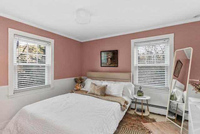 bedroom featuring ornamental molding, a baseboard radiator, and multiple windows