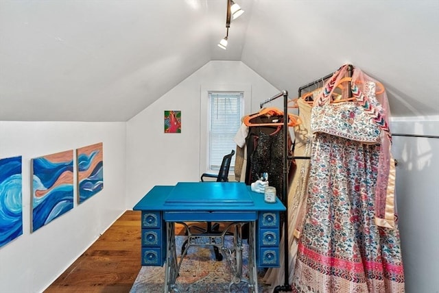 interior space featuring lofted ceiling and track lighting