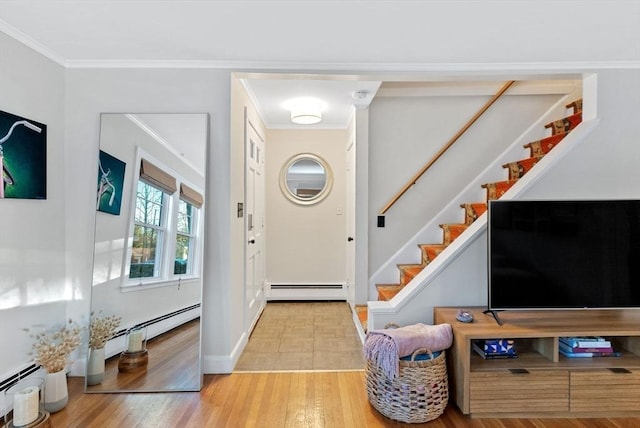 foyer entrance with crown molding, light wood finished floors, baseboard heating, a baseboard heating unit, and stairs