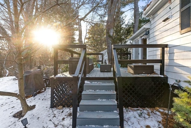 yard covered in snow featuring a wooden deck and stairs