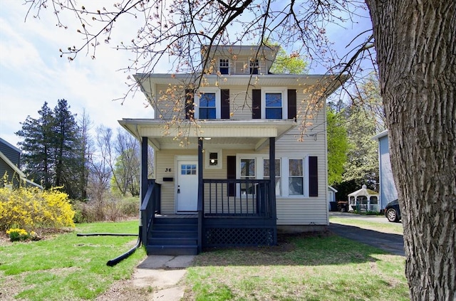 traditional style home featuring a porch and a front yard