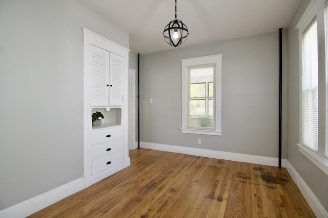 unfurnished dining area with a healthy amount of sunlight and light wood-style floors