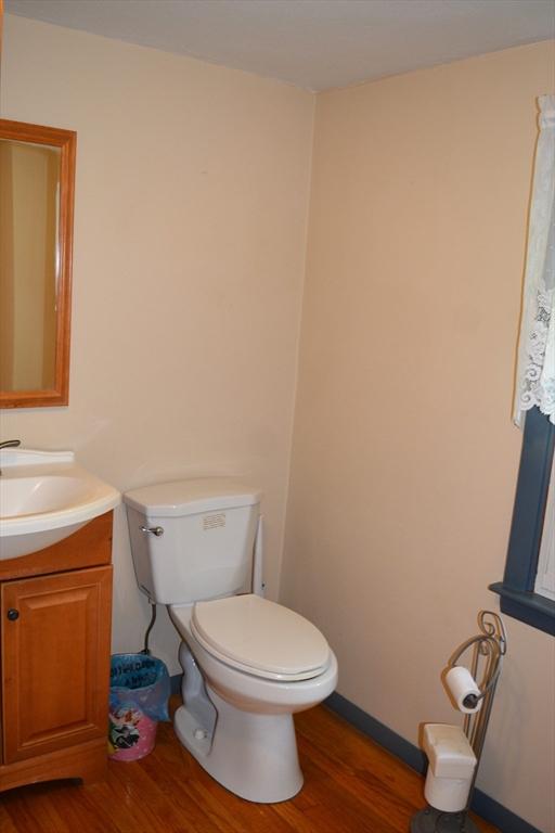181 Adrian Ave, West Springfield, MA 01089 - half bathroom with wood finished floors, vanity, toilet, and baseboards