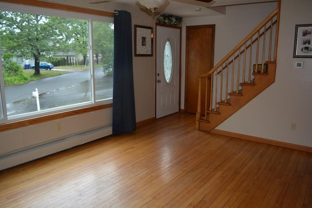 181 Adrian Ave, West Springfield, MA 01089 - foyer entrance featuring ceiling fan, a baseboard radiator, light wood-style flooring, stairs, and baseboards