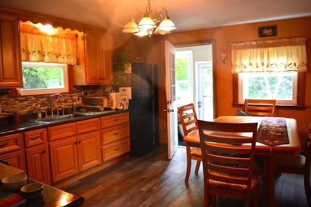 181 Adrian Ave, West Springfield, MA 01089 - kitchen with freestanding refrigerator, a sink, a chandelier, dark countertops, and plenty of natural light