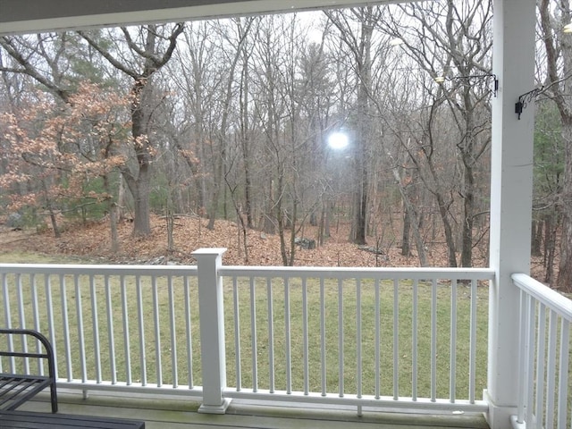 wooden terrace featuring a lawn