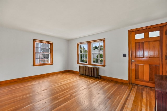 foyer featuring radiator and light hardwood / wood-style flooring