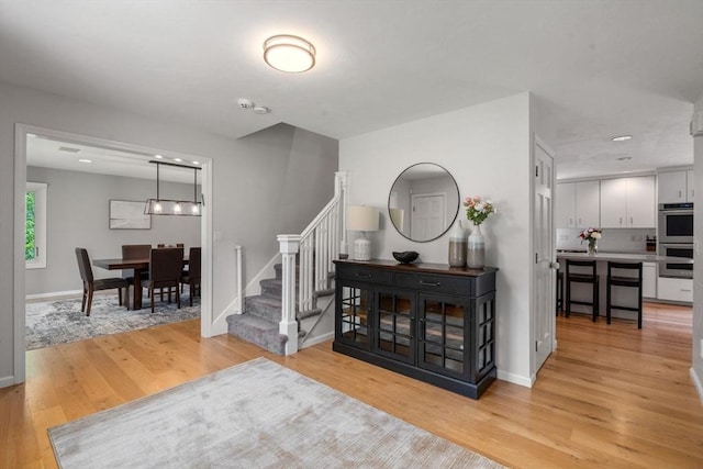 66 Ashcroft Rd, Sharon, MA 02067 - entryway featuring stairway, light wood-style flooring, baseboards, and recessed lighting