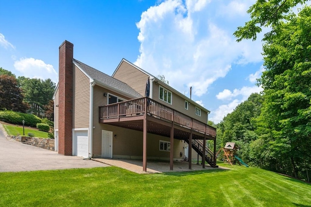 66 Ashcroft Rd, Sharon, MA 02067 - back of house featuring a deck, a chimney, an attached garage, a lawn, and a playground