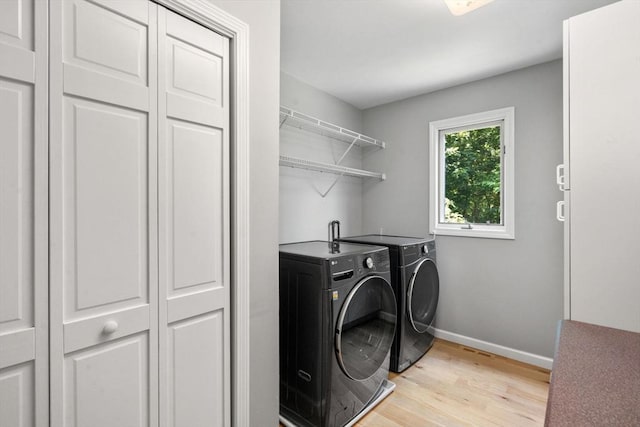 66 Ashcroft Rd, Sharon, MA 02067 - laundry area featuring washer and dryer, light wood-type flooring, and baseboards