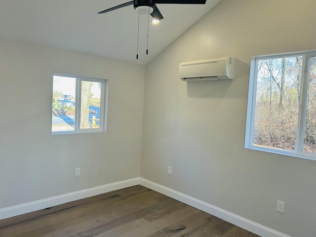 empty room featuring dark hardwood / wood-style floors, a healthy amount of sunlight, and a wall unit AC