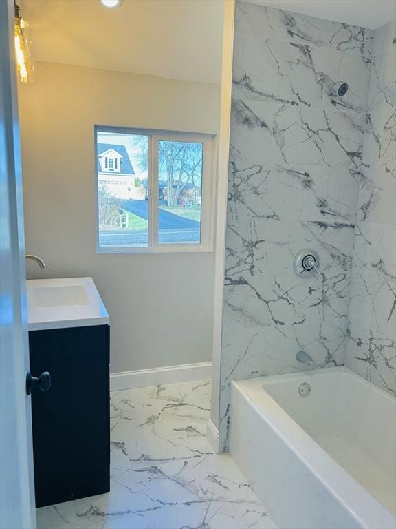 bathroom featuring vanity and tiled shower / bath