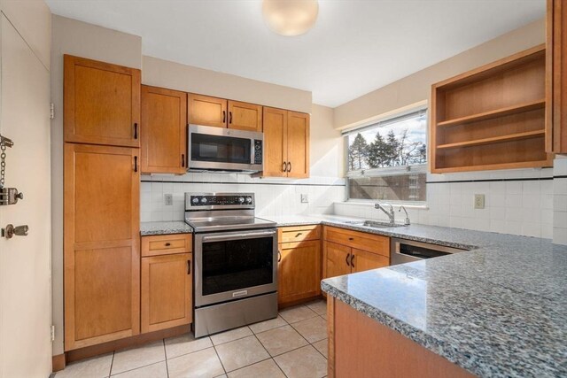 kitchen with light tile patterned floors, open shelves, a sink, stainless steel appliances, and backsplash