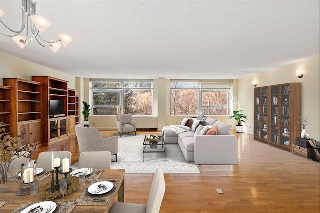 living area featuring light wood finished floors and a notable chandelier