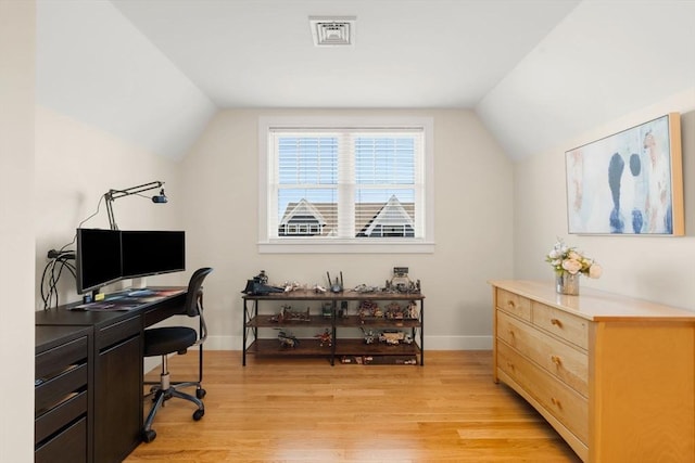 office with baseboards, visible vents, light wood-style flooring, and lofted ceiling