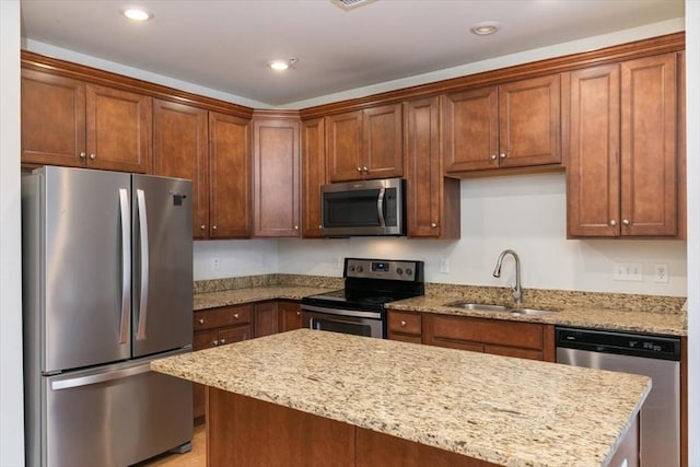 1 Francis Dr Unit 211, Andover, MA 01810 - kitchen with stainless steel appliances, a sink, a kitchen island, light stone counters, and recessed lighting