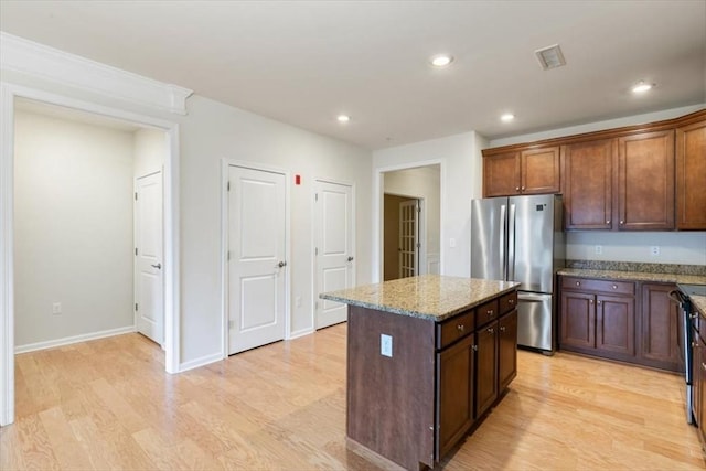 1 Francis Dr Unit 211, Andover, MA 01810 - kitchen featuring freestanding refrigerator, light wood-style floors, light stone counters, a center island, and recessed lighting