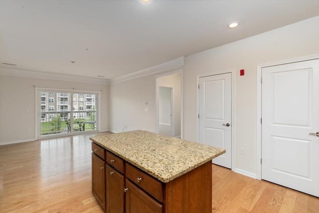 1 Francis Dr Unit 211, Andover, MA 01810 - kitchen with light wood-style floors, a center island, open floor plan, light stone countertops, and crown molding