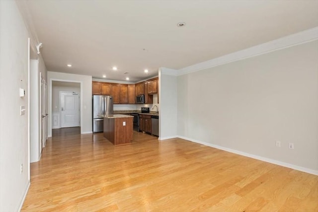 1 Francis Dr Unit 211, Andover, MA 01810 - kitchen with stainless steel appliances, open floor plan, a kitchen island, light wood-type flooring, and baseboards